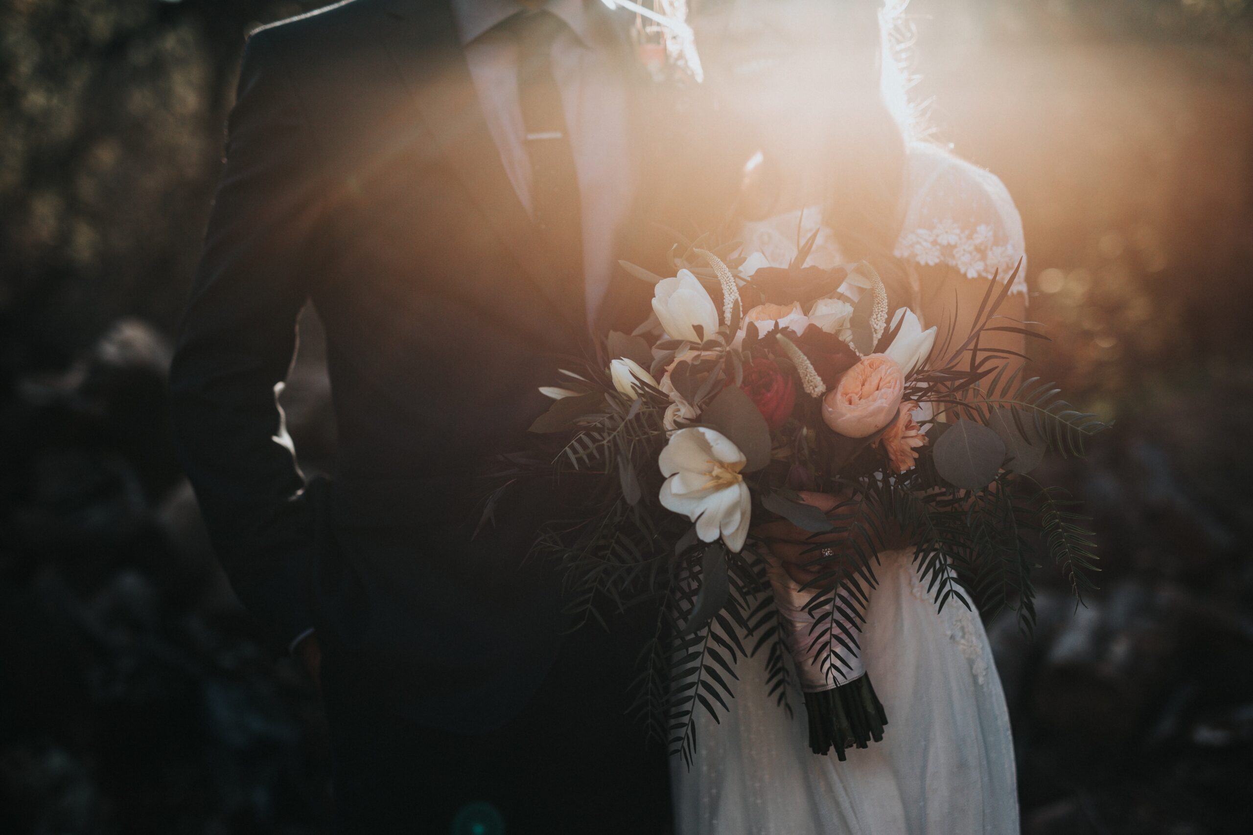 bride holding flowers next to her groom